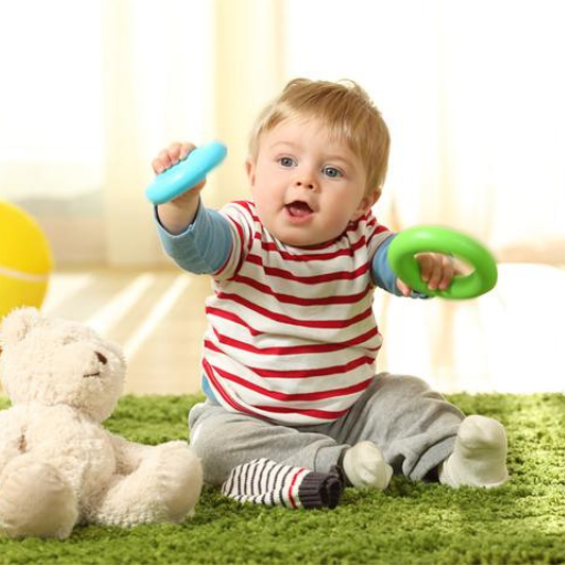 Un bebé jugando con aros de estimulación de motricidad fina.